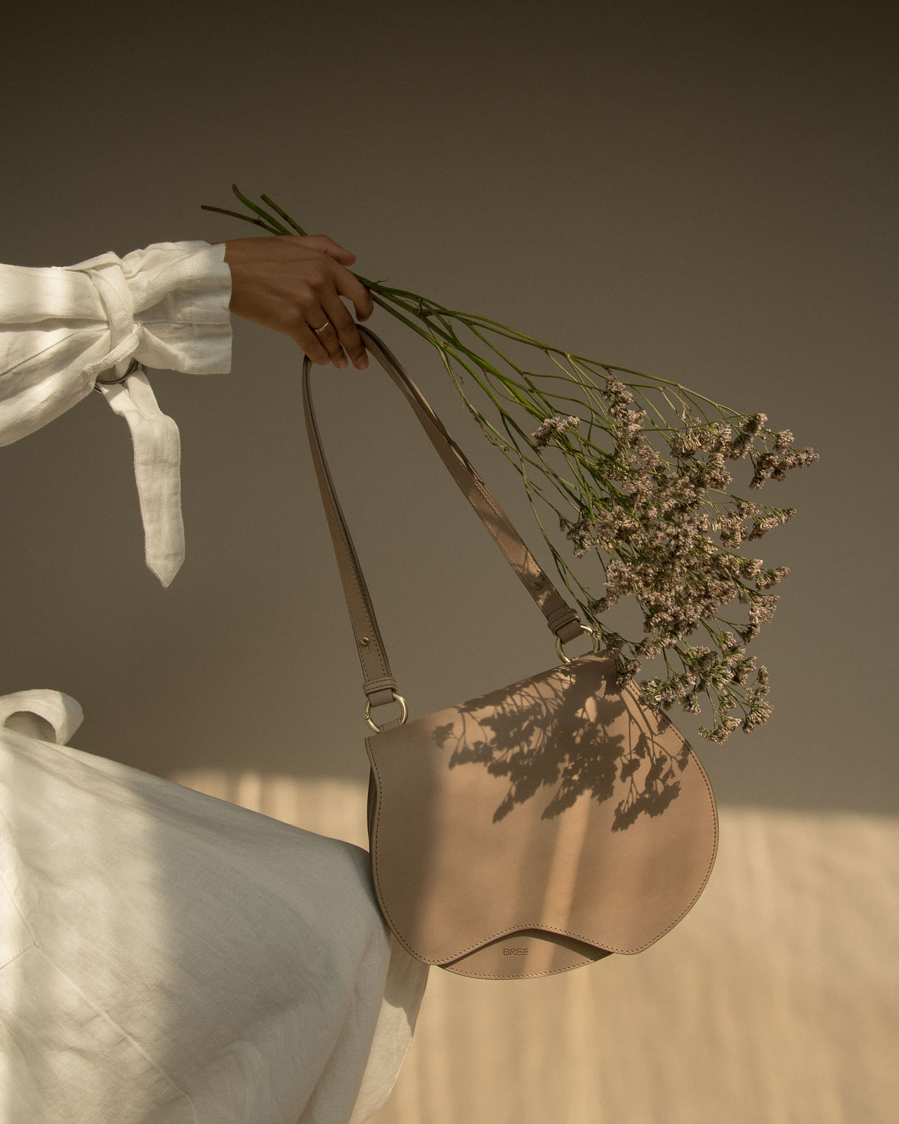 storm wears blanche copenhagen white linen coat with bree nature beauty bag in color humus shot by marius knieling