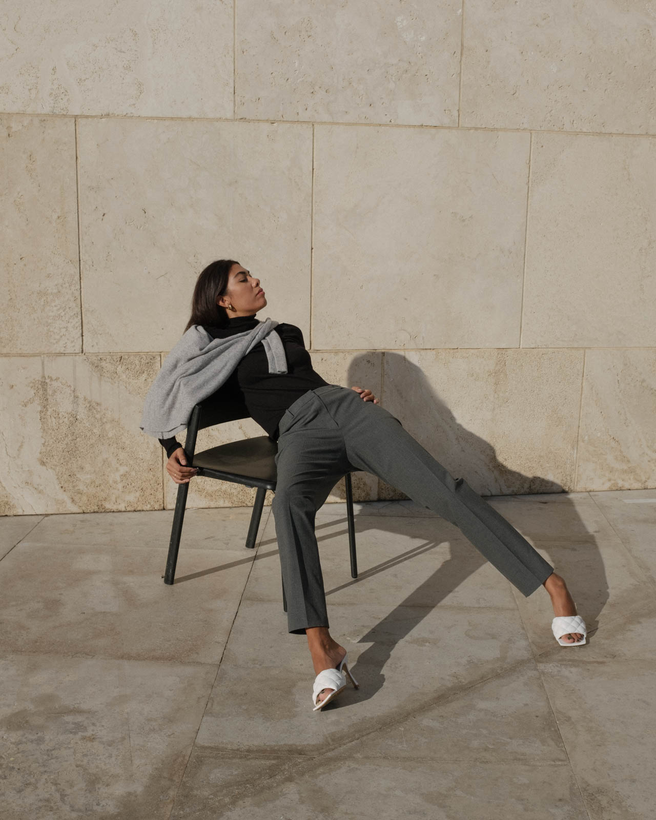 storm wes wears jake*s cashmere sweater grey and black turtleneck sweater with grey business pants and white Bottega veneta Mules