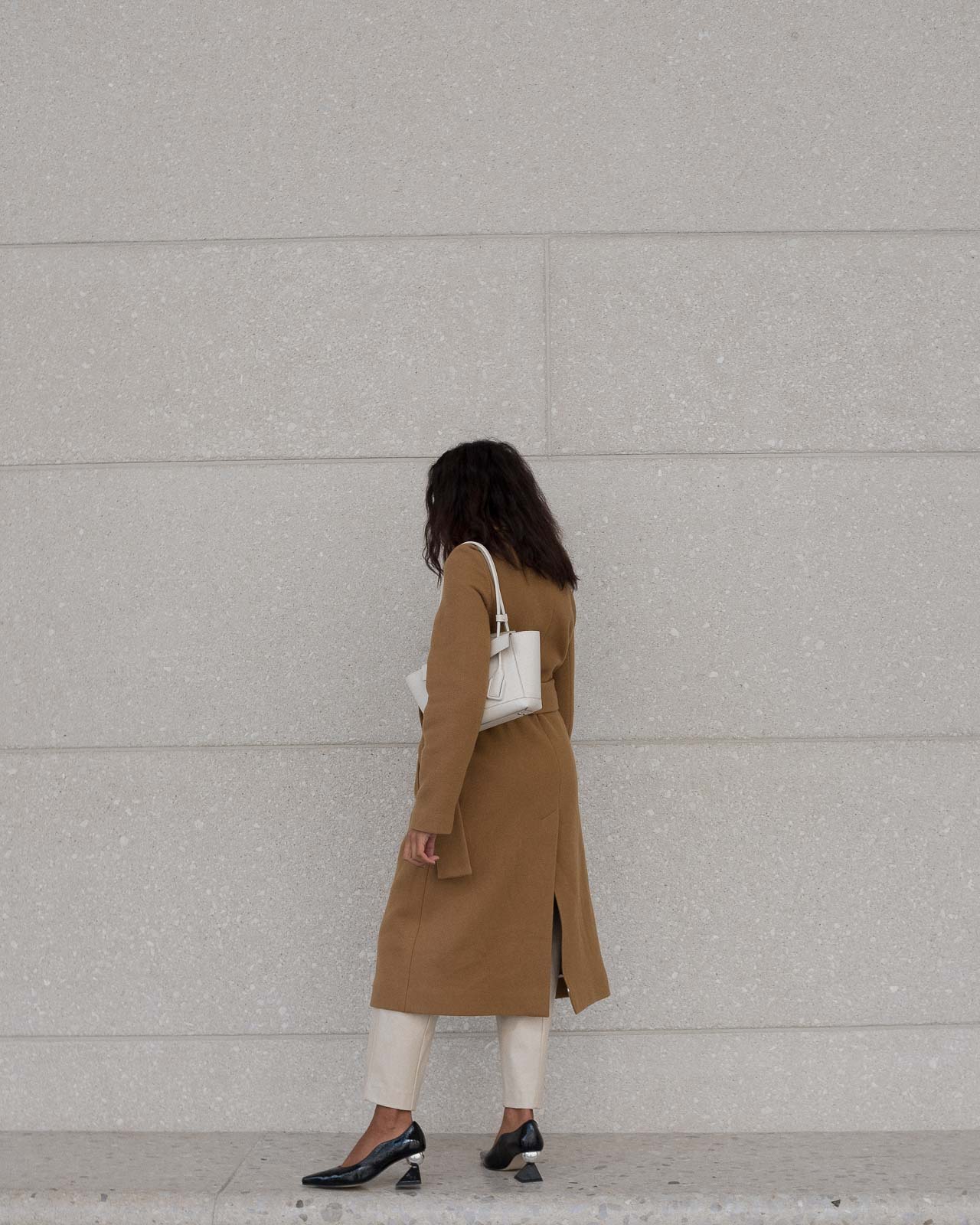 storm wears yuul yie black mules combined with camel coat from by malene birger 