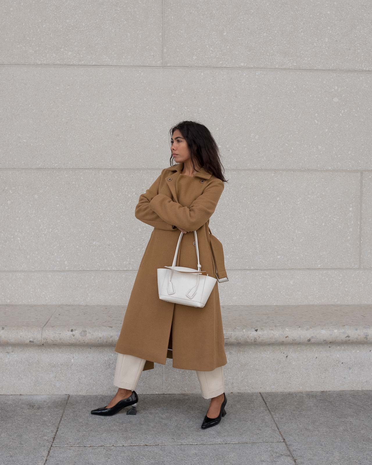 storm wears white bottega veneta arco bag with yuul yie black mules combined with by malene birger camel coat