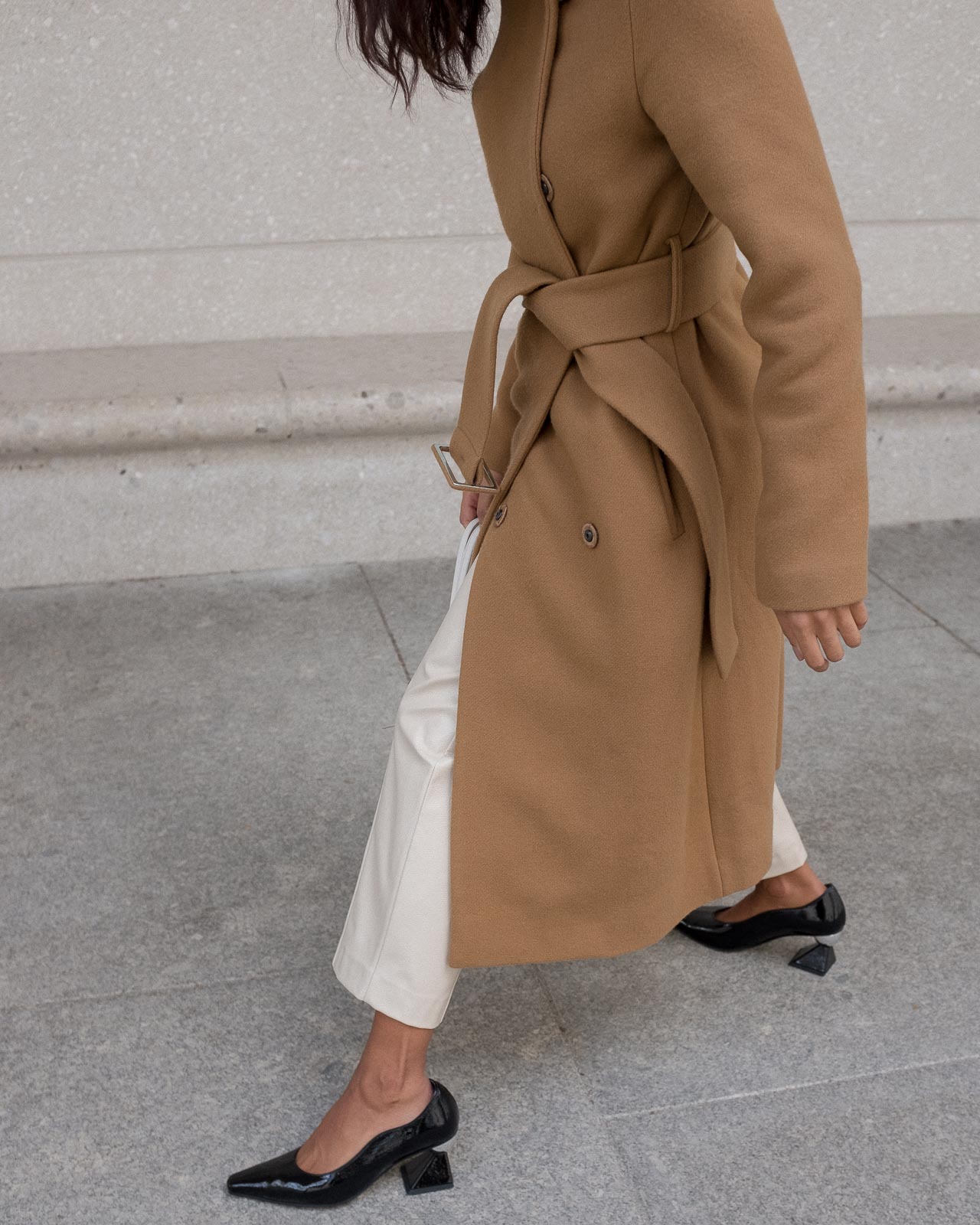storm wears weekday creme pants combined with yuul yie black mules and by malene birger camel coat